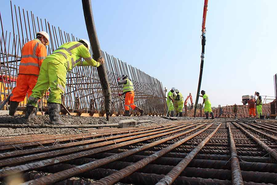 Concrete being poured by a Barrow Mix pump