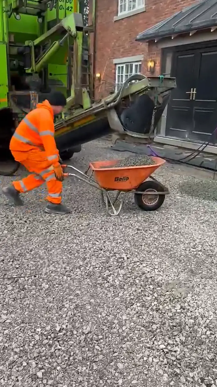 Barrow Mix worker barrowing no-fines concrete from the truck at a Knutsford driveway