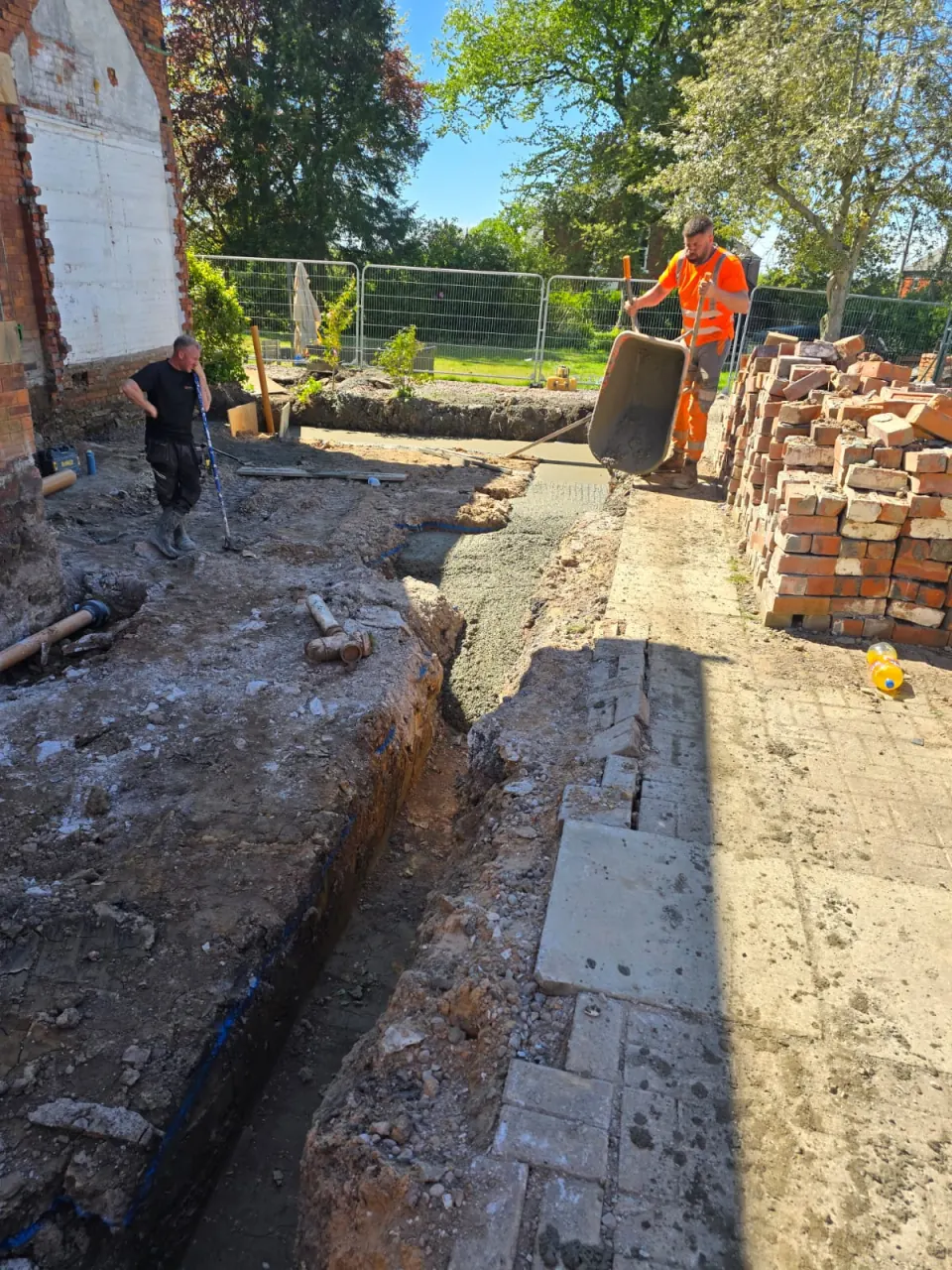 Pouring concrete into a house extension footing in Marple Bridge