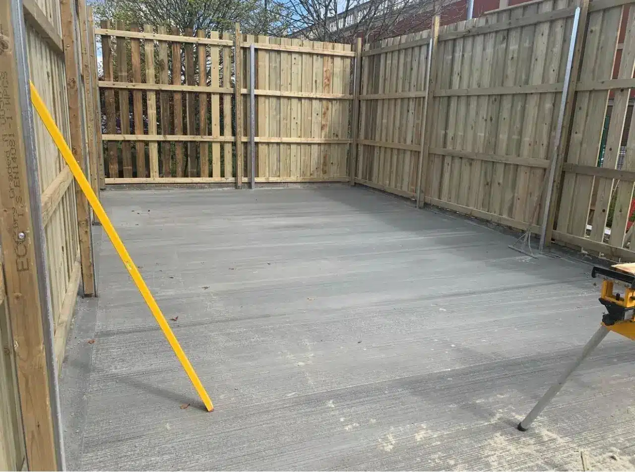 Finished concrete base inside the new fenced waste bin store at Krispy Kreme in Trafford Park