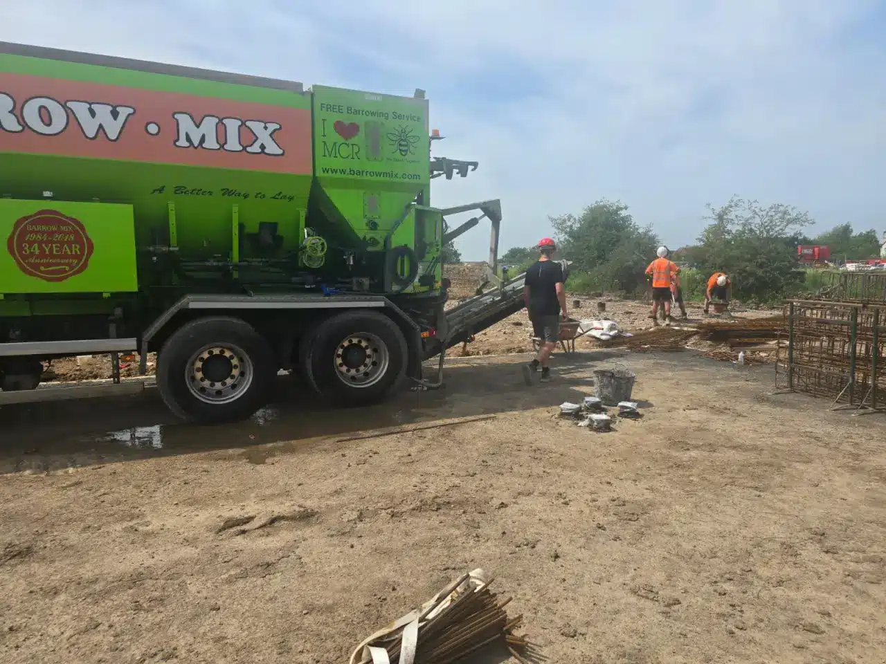 Barrow Mix truck discharging concrete with its free barrowing service