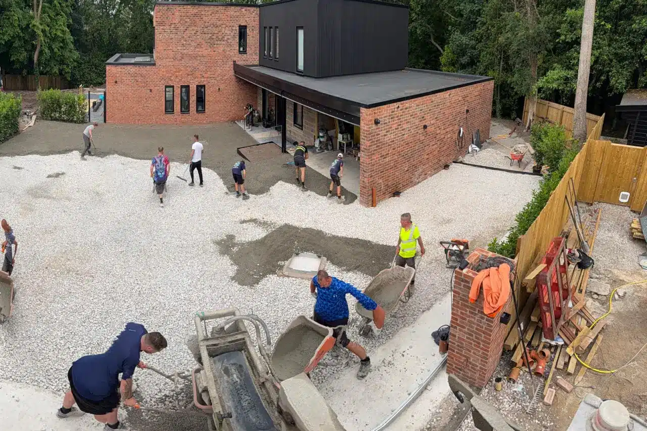 Aerial view of a large no-fines concrete driveway being laid by the Barrow Mix team at a modern house in Knutsford