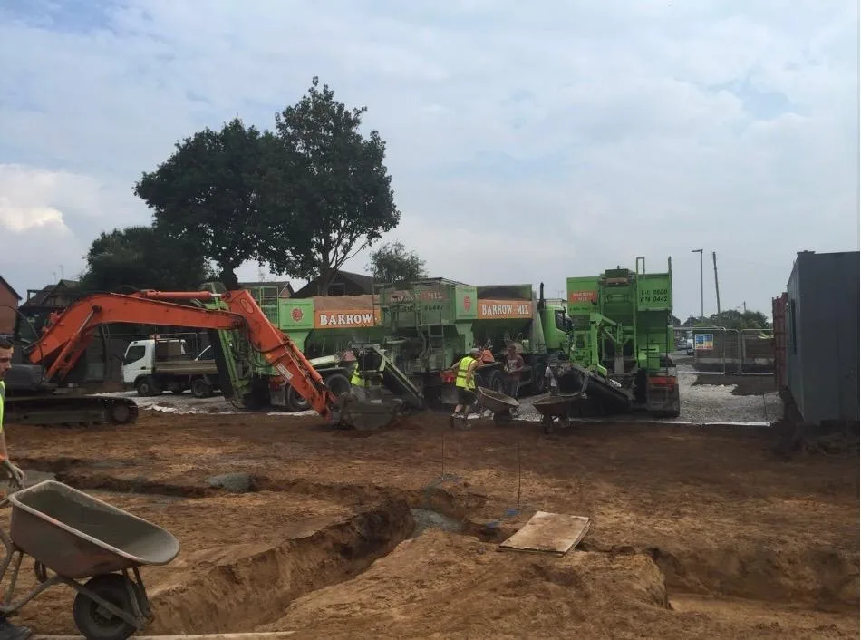 Excavator and Barrow Mix wagons working the footings on the Lymm site