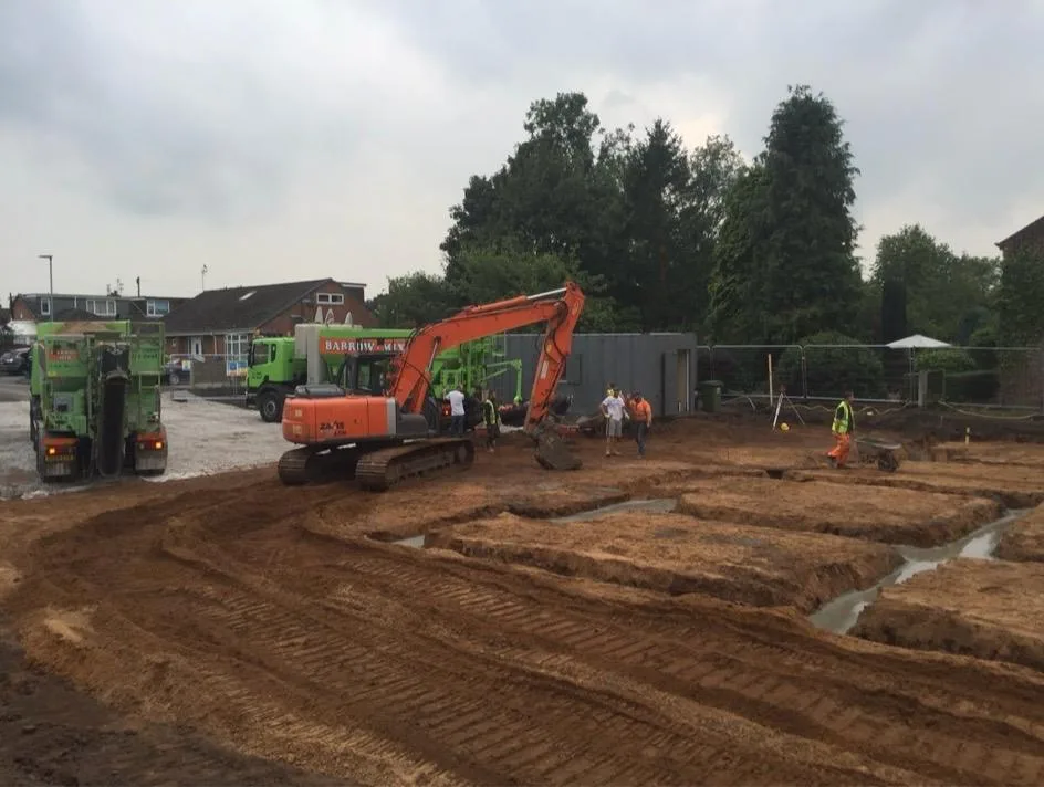 Wide view of the Lymm townhouse development with Barrow Mix wagons pouring the footings