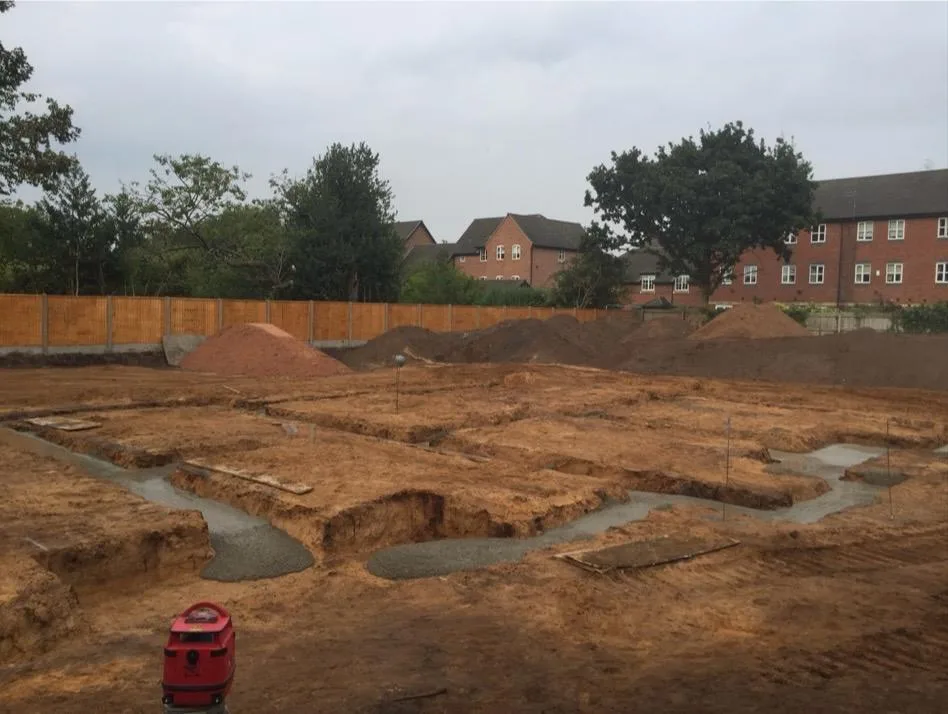Freshly poured concrete footings across the Lymm townhouse plot