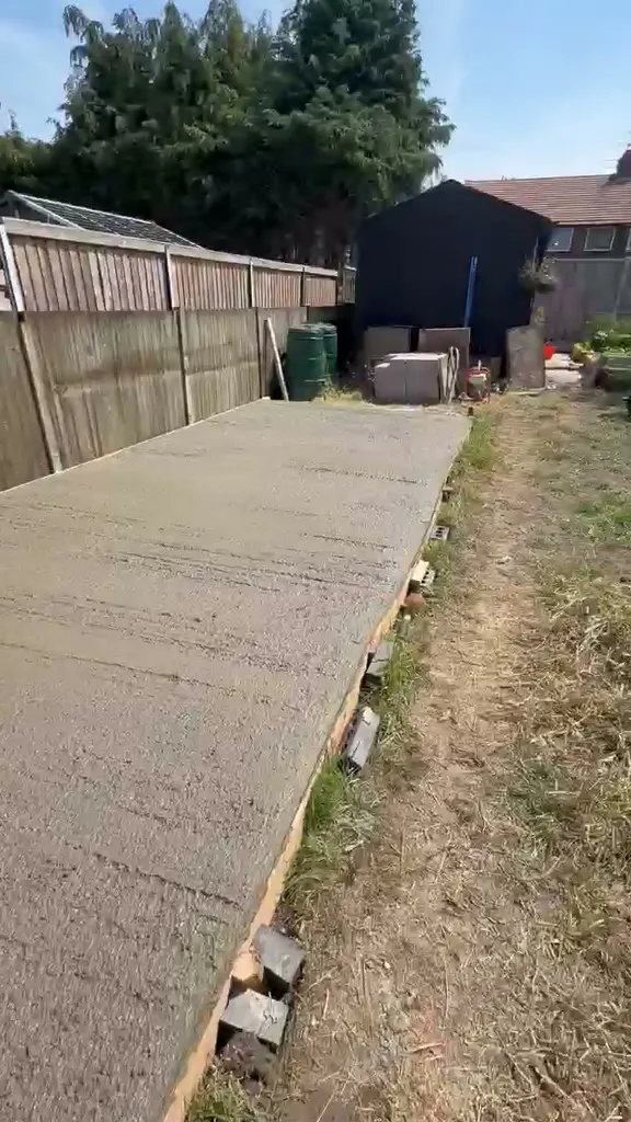 A long concrete base laid down a back garden in Cuddington ready for a pigeon loft
