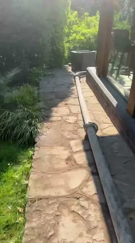 Barrow Mix concrete pump line running along a garden path to a base at the back of a Wilmslow garden