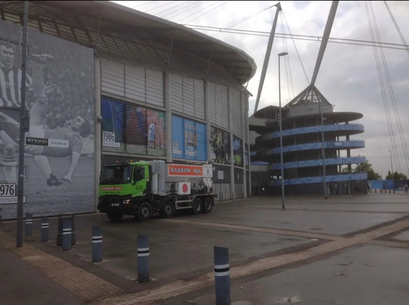 Barrow Mix wagon in front of the Etihad Stadium spiral ramp tower in Manchester