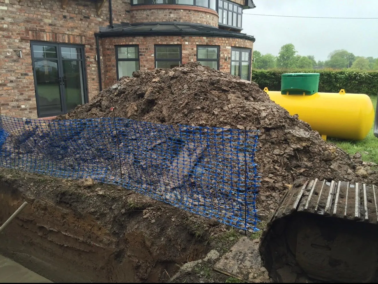 New bulk LPG gas tank beside its concrete anchor base at a new build in Mobberley, Cheshire
