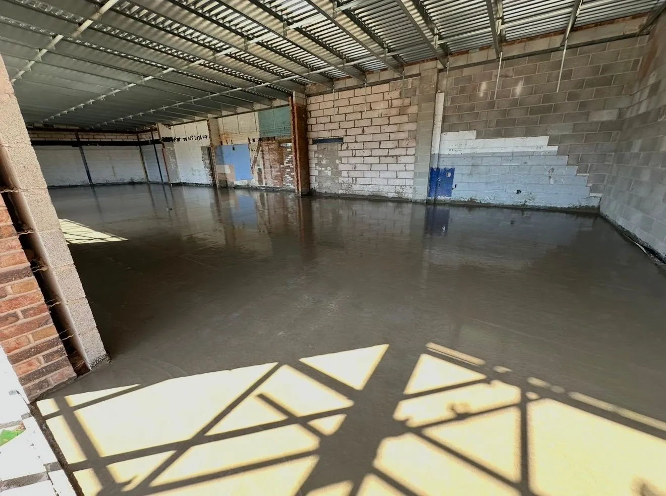 Sunlight across the newly pumped concrete floor inside the Tesco Express unit in Cadishead