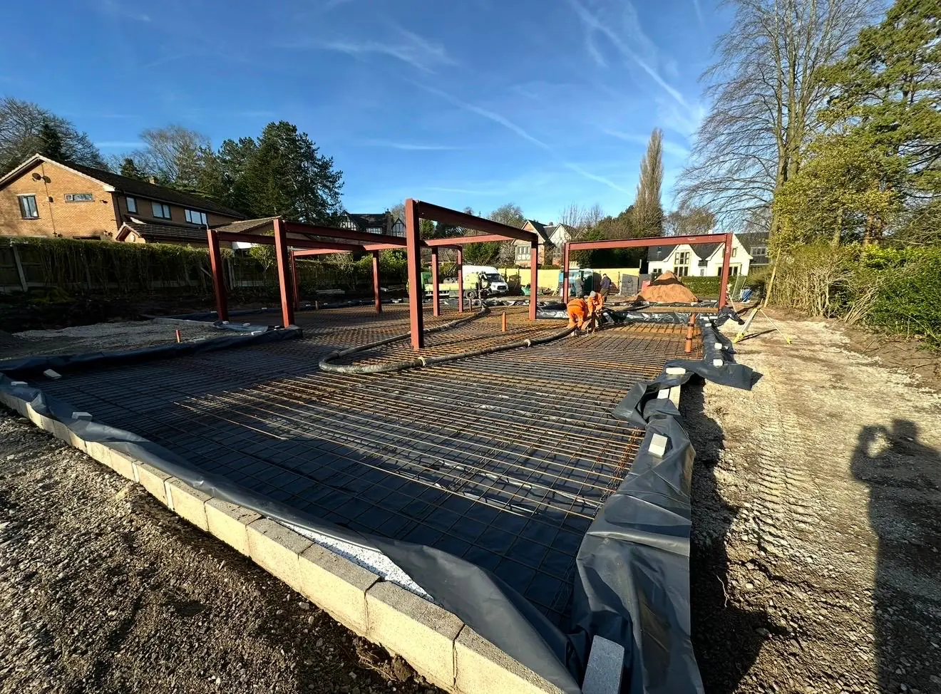 Reinforcement and edge formwork across the new-build slab area near Bowdon