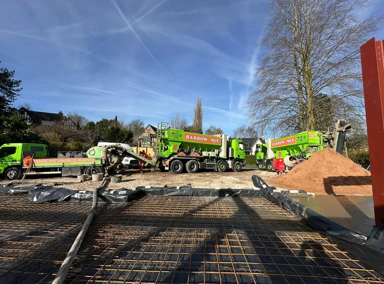 Barrow Mix wagons and the concrete pump at the edge of the slab near Bowdon