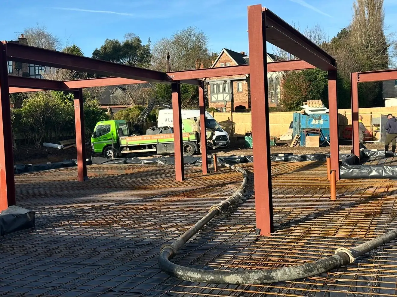 Concrete pump line run across the steel mesh between the steel frames near Bowdon