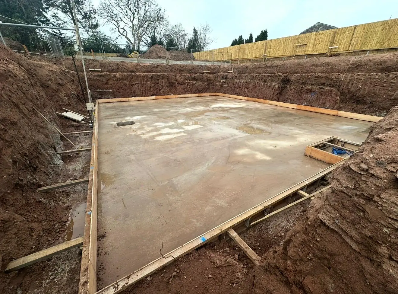 Concrete swimming pool base laid inside timber shuttering in Sale